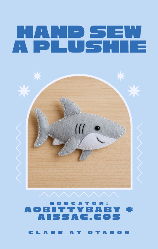 Plush shark toy on a wooden board with text about sewing a plushie, on a light blue background.